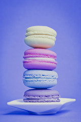 Sweet and colourful french macaroons on background