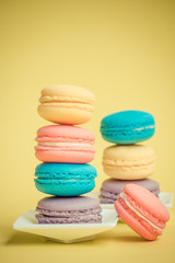 Sweet and colourful french macaroons on background