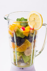 Mixed exotic fruits with leaf of mint in the blender