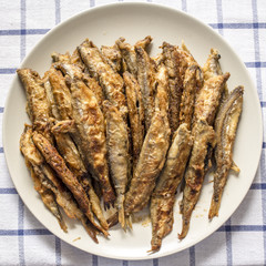 plate with fried crispy fish is on the table