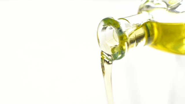 close up of bottle pouring olive oil
