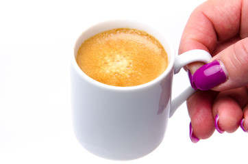 A woman's hand holding a cup of coffee