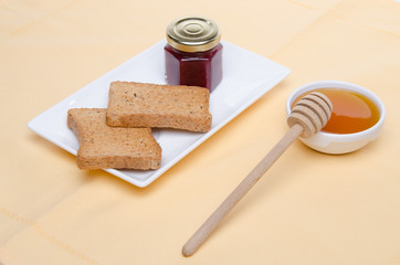 Composition of breakfast, honey, toasts,jam