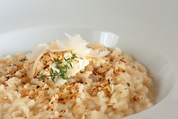 Risotto topped with shaved Parmesan and thyme