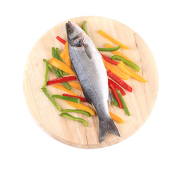 Fresh seabass fish on colorful pepper.