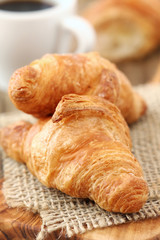 Breakfast with fresh croissant and coffee at the background