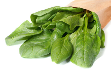 Spinach leaves in paper packing isolated on a white