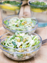 salad with fresh vegetables in glass bowl on the  table
