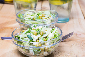 salad with fresh vegetables in glass bowl on the  table