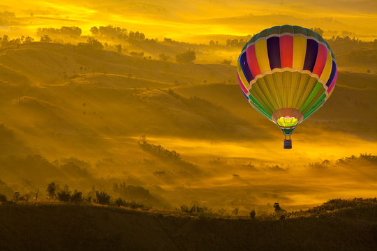 Hot Air Balloon Over Mountainous Autumn Landscape