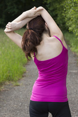 Fototapeta na wymiar Rear view of a woman stretching outdoors