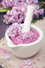Obraz na płótnie Canvas Spa sea salt in mortar and lilac flowers. Spa set.