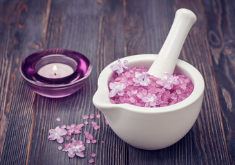 Obraz na płótnie Canvas Spa sea salt in mortar and lilac flowers. Spa.