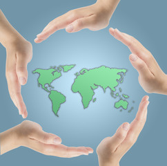 Human hands surrounding the Earth