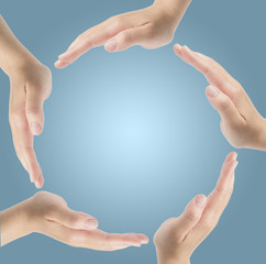Group of hands forming a circle isolated on blue background