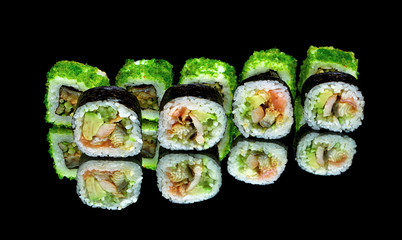 Japanese rolls close-up on black background with reflection