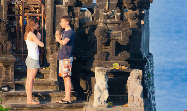 couple meditating near the temple. Indonesia, Bali