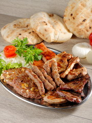 Wholesome platter of mixed meats including grilled steak.
