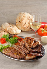 Mixed grill on a plate with excellent wine