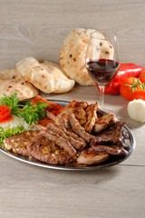 Mixed grill on a plate with excellent wine