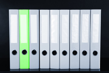 Concept of individuality.One bright color folder among grey
