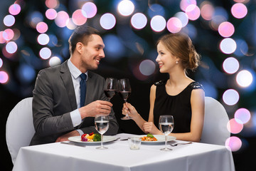 smiling couple eating main course at restaurant