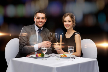 smiling couple eating main course at restaurant