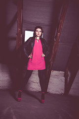 Fashion woman in pink dress and leather jacket at loft