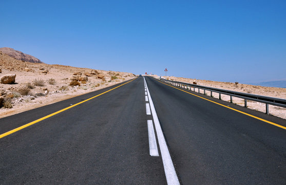 Empty curved roadroad in the desert