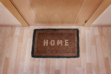 Welcome home doormat with closed door