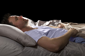 close up of insomniac unable to sleep in bed