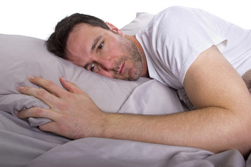 close up of insomniac unable to sleep in bed