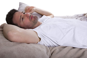 close up of insomniac unable to sleep in bed