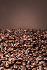 Coffee beans on brown background