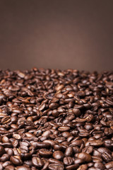 Coffee beans on brown background