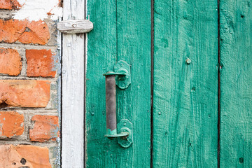 Old weathered door with knob.