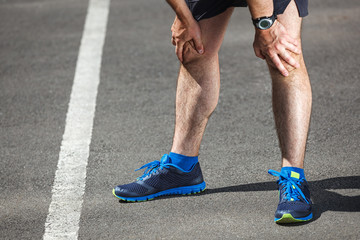 Tired male runner resting after training.
