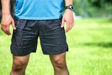 Closeup of a male runner standing - space for text.