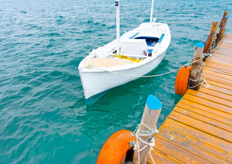 Wooden pier with fishing boats at Poros island in Greece