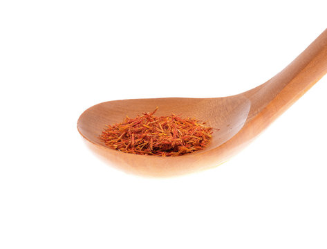 Indian saffron in wooden spoons isolated white background .