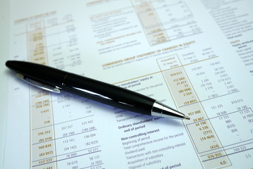Naklejka na ściany i meble pen lying on a document of financial figures