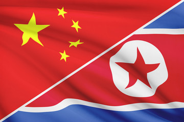 Series of ruffled flags. China and North Korea.