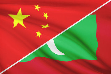 Series of ruffled flags. China and Republic of the Maldives.