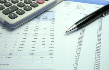pen and calculator on financial documents
