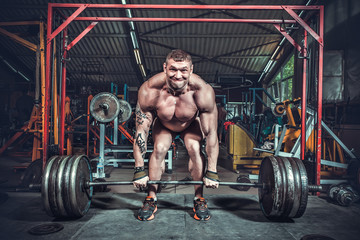 Fototapeta na wymiar Powerlifter with strong arms lifting weights