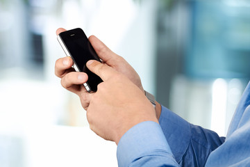 Businessman holding  and using the  mobile  smart  phone