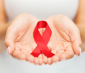hands holding red AIDS awareness ribbon