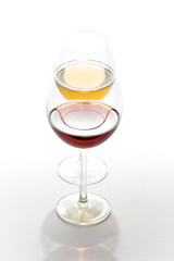 Two tall glasses  filled with red and white wine