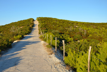 The narrow road across the top of the hill