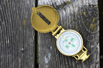 Compass on the wooden background
